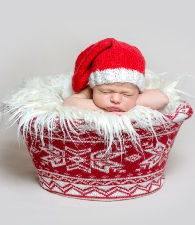 Newborn baby in santa claus bonnet